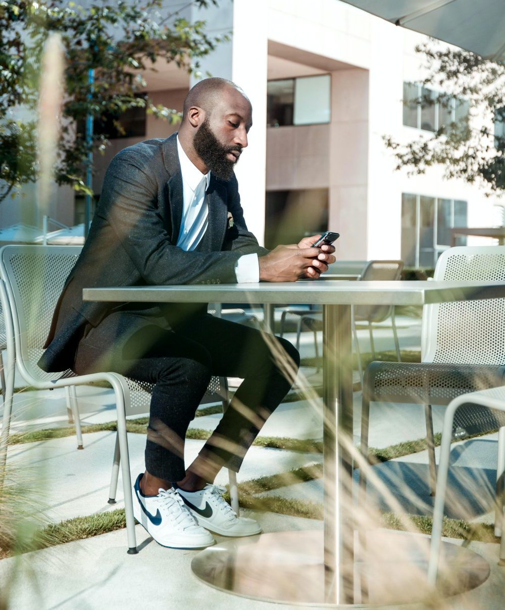 job-search-strategy-black-man-on-phone-nike-sneakers