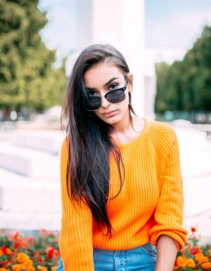 passive-income-ideas-millennials-woman-sweater-sunglasses-alexander-mils-unsplash